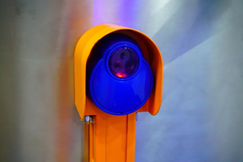 Garage door safety inspection by American Garage Door Solutions in San Mateo — technician testing auto-reverse sensors