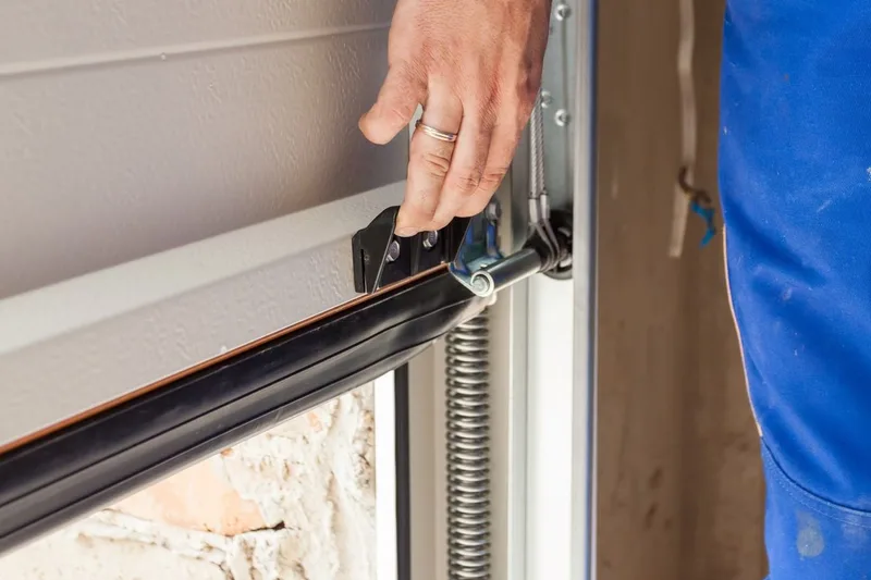 Professional garage door tune-up service by American Garage Door Solutions in Daly City, CA — technician inspecting springs and rollers